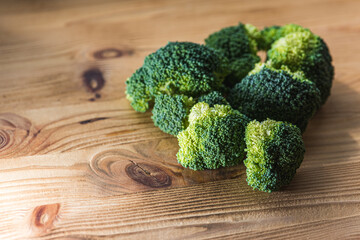 green broccoli on wooden background, top view, concept of healthy eating, food