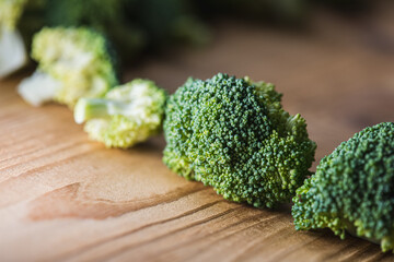 green broccoli on wooden background, top view, concept of healthy eating, food