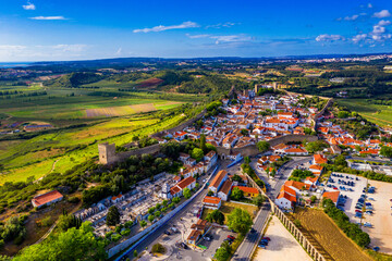 Aerial view of the historic walled town of Obidos at sunset, near Lisbon, Portugal. Aerial shot of Obidos Medieval Town, Portugal. Aerial view of medieval fortress in Obidos. Portugal.