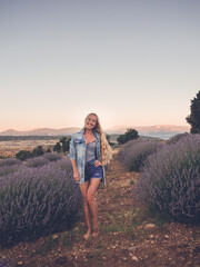 Fototapeta premium Blonde woman in denim jacket in the field
