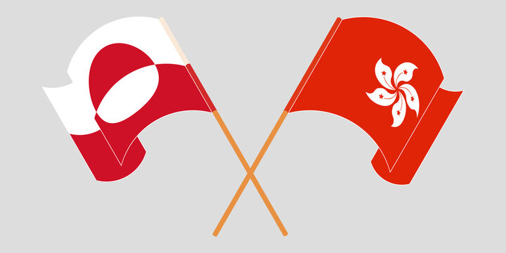 Crossed and waving flags of Greenland and Hong Kong