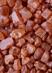 Handful of red Hawaiian sea salt isolated on white background