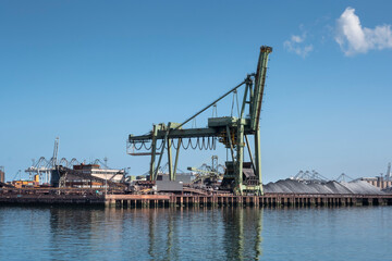 Fototapeta na wymiar Type of cargo terminal and cranes, berths for transshipment of bulk cargo, iron ore and coal