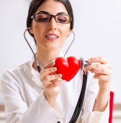 Young doctor in heart care concept