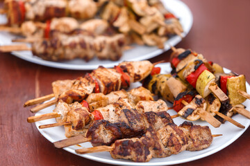 Shish kebab on wooden skewers is on a plate