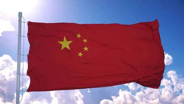 China flag on a flagpole waving in the wind against deep blue sky. The People's Republic of China
