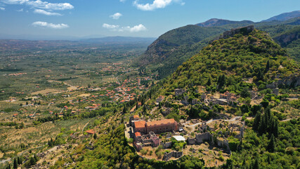 Fototapeta na wymiar Aerial drone photo of medieval byzantine old city of Mystras featuring Monastery of Pantanassa, Temple of Agia Sofia and uphill castle of Mystras, Sparta, Peloponnese, Greece