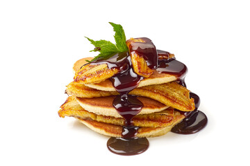 Stack of pancakes with fried banana, mint leaf and chocolate syrup on white