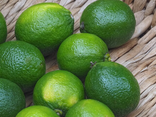 Sweet green limes in a basket on a food market