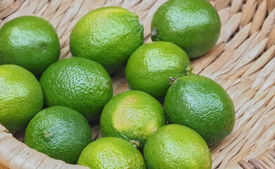 Sweet green limes in a basket on a food market