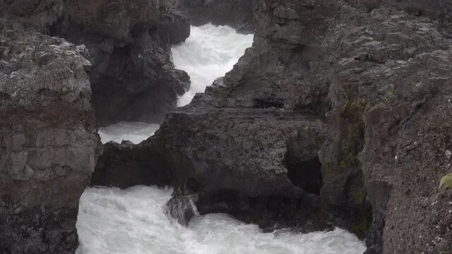 Powerful whitewater rapids through volcanic terrain Barnafoss Iceland