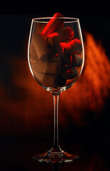 Wine glass with corks on black background