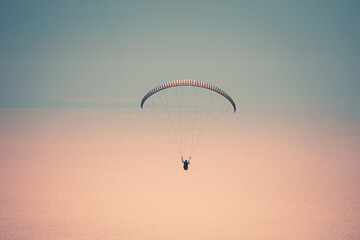 Paraglider tandem flying over the Oludeniz at sunset. Fethiye, Mugla.