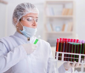 Woman doctor checking blood samples in lab