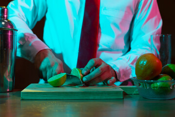 Barman preparing drink with shaker