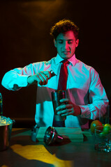 Barman preparing drink with shaker