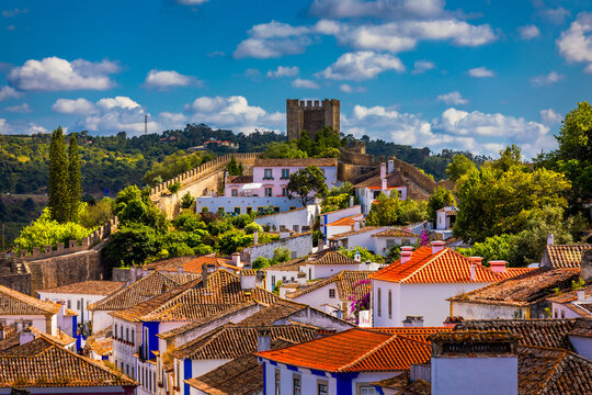 Historic walled town of Obidos, near Lisbon, Portugal. Beautiful streets of Obidos Medieval Town, Portugal. Street view of medieval fortress in Obidos. Portugal.