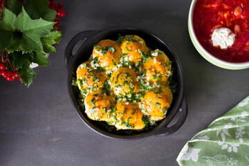 Buns Pampushky - Ukrainian garlic bread. Bread rolls with garlic and parsley, bowl of soup borsht. View from above, top studio shot