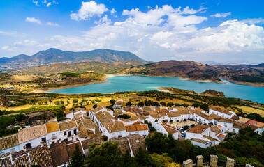 Fototapeta premium white village roof with lake and mountains in the background
