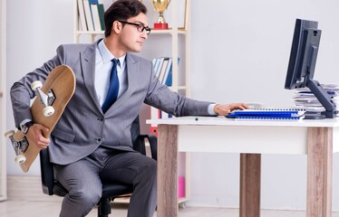 Young businessman riding skate in office during break