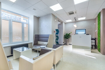 Naklejka na ściany i meble Inside the modern office: a stylish waiting area and high-tech reception counter