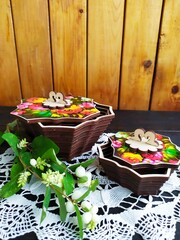 Items of Russian traditional national craft lace napkin wooden boxes tray with painting white berries on a twig