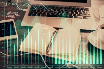 Multi exposure of financial graph drawings and desk with open notebook background. Concept of forex