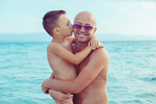 son kissing father on the cheek