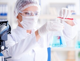 Female scientist researcher conducting an experiment in a labora