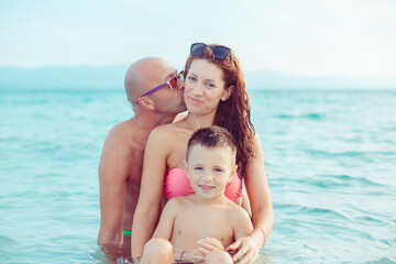 Fototapeta na wymiar happy young family have fun while in vacations on the sea