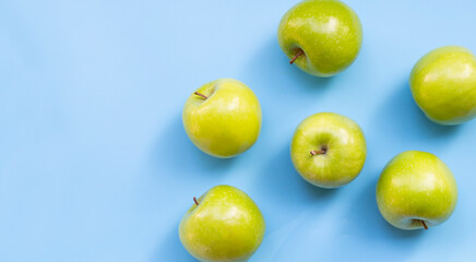 Green apples on blue background.