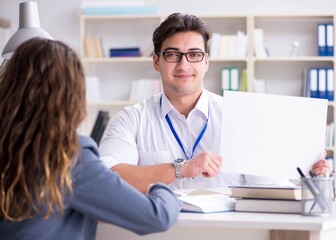 Sales assistant discussing transaction with customer