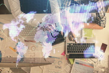 Double exposure of man and woman working together and business theme hologram drawing. Computer background. Top View.