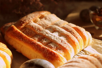 Baking from sweet yeast dough with fruits inside close-up, homemade bread.