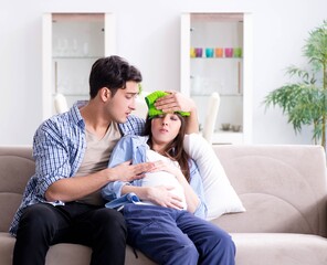 Pregnant woman with husband at home