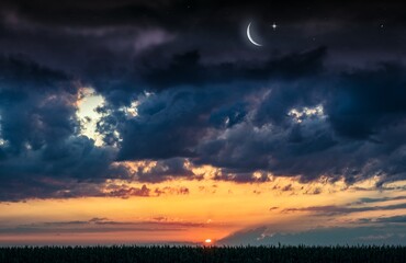 Ramadan background with a crescent and sunset sky 