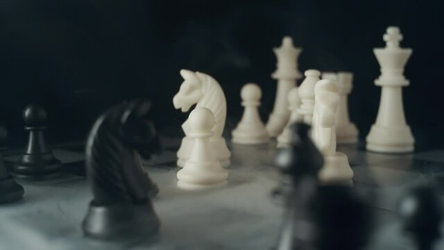 Chess pieces on a chessboard in a fashion style. Soft pleasant lighting. Creeping smoke across the board. Fashion, start up, business concept. Depth of field, soft focus . Red camera, 4K UHD