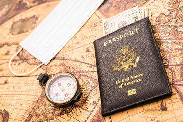 American passport in patriotic background for travelers with a mask.