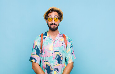 young bearded tourist man looking worried, stressed, anxious and scared, panicking and clenching...