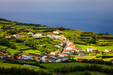 View of Pedreira village at northeast coast of Sao Miguel island, Azores, Portugal. View of Pedreira village and Pico do Bartolomeu at northeast coast of Sao Miguel island, Azores, Portugal.