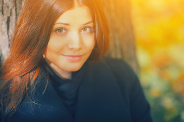 Autumn woman portrait. Fall fashion. Young girl hair beauty. Happy model face. Pretty female lifestyle. Smile lady people outdoor on nature background. Season street style. Yellow red september leaves