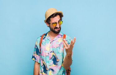 young bearded tourist man looking angry, annoyed and frustrated screaming wtf or what‚Äôs wrong...