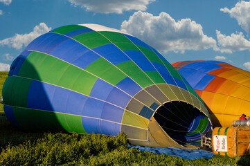 Obraz premium Two hot air balloons on the ground and getting filled to fly 