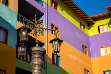 Fototapeta na wymiar street lamp with colorful building background