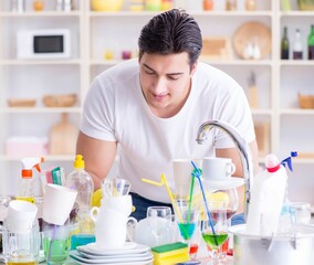The man enjoying dish washing chores at home