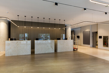 Interior of a hotel lobby with reception desks with transparent covid guards