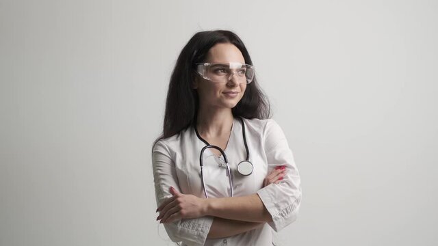 Doctor in a white coat posing at the camera