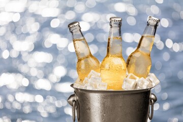 Bottles of cold and fresh beer with ice in the bucket