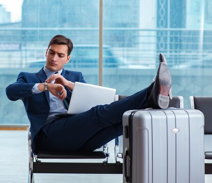 Businessman waiting at the airport for his plane in business cla