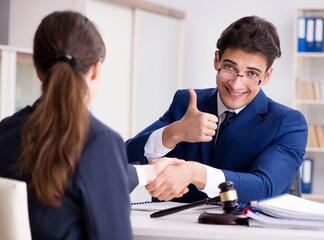 Lawyer talking to his client in office